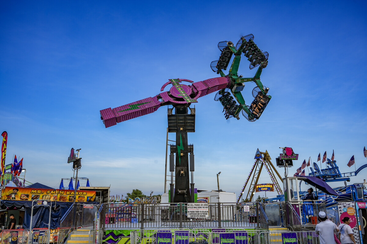 Dreamland Amusements thrill ride against a bright blue summer sky